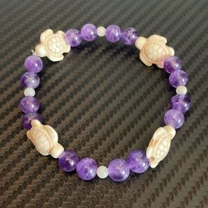 This is an amethyst bracelet. It’s great for keeping calm and feeling relaxed!!